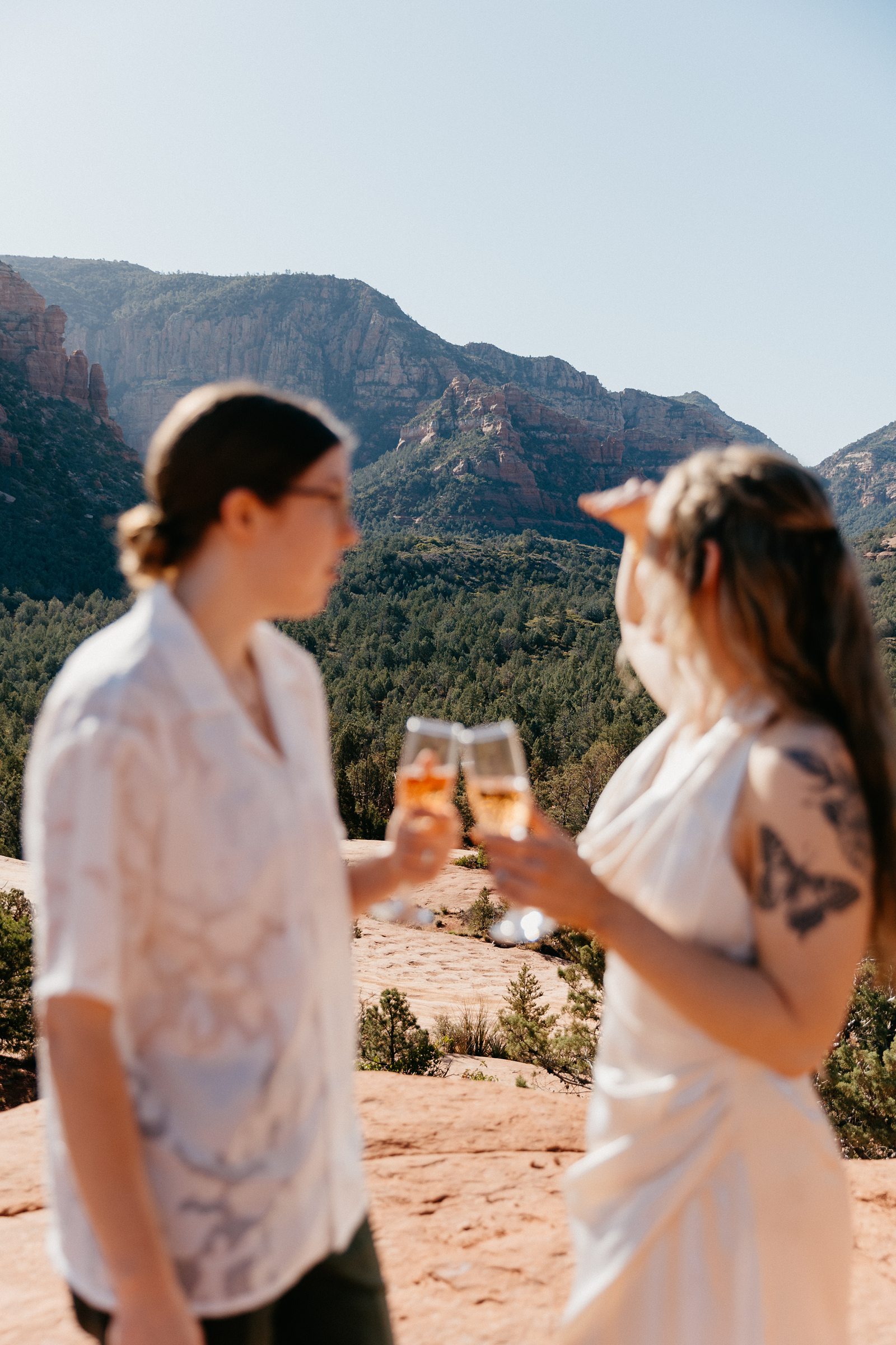 couple cheersing champagne with sedona view