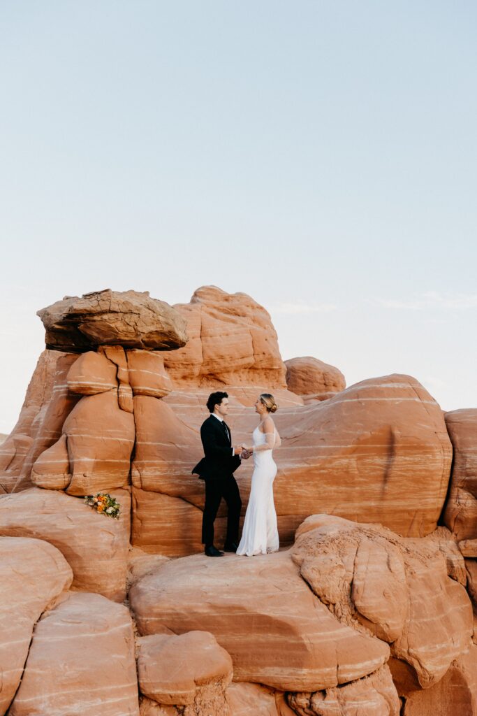 Couple reciting vows in top Arizona elopement location with red rocks and hoodoos